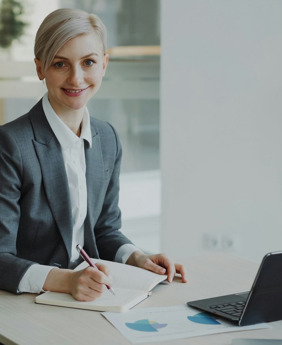 A business owner reviewing tax paperwork at a bright, tidy desk